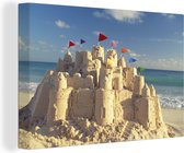 Canvas Schilderij Zandkasteel op het strand - 180x120 cm - Wanddecoratie XXL