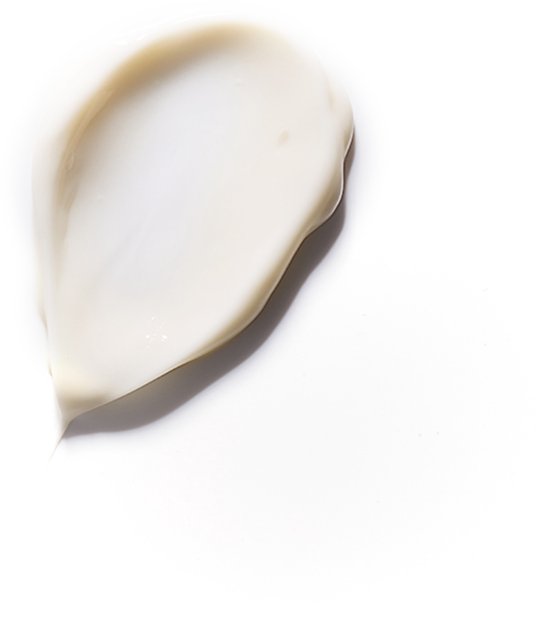 Een witte, romige textuur van Phytorelax scheercrème op een witte achtergrond.
