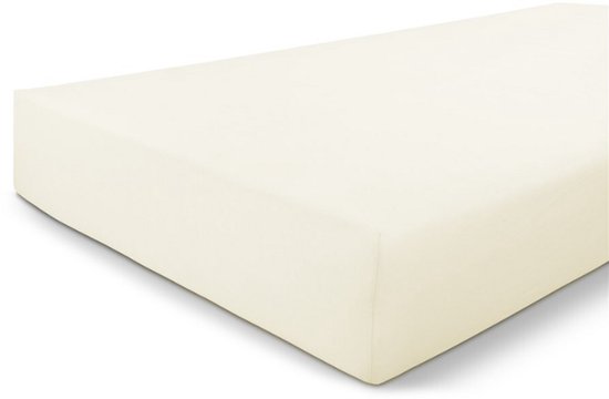 Crèmekleurig jersey hoeslaken op een matras.