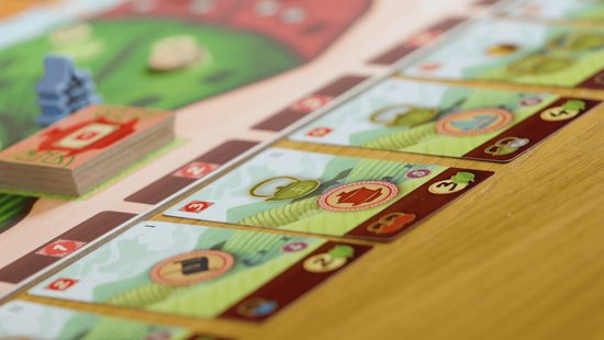 Bordspel met kaarten met theepotten, bladeren en Chinese symbolen op een groene en bruine achtergrond.