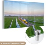 MuchoWow® Glasschilderij 120x60 cm - Schilderij acrylglas - Een trein rijdt door een landschap - Foto op glas - Schilderijen