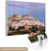 MuchoWow® Glasschilderij 90x60 cm - Schilderij acrylglas - Skyline van Ostuni in Italië - Foto op glas - Schilderijen