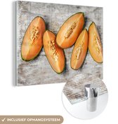 MuchoWow® Glasschilderij 120x90 cm - Schilderij acrylglas - Cantaloupe meloen in stukken - Foto op glas - Schilderijen