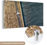 MuchoWow® Glasschilderij 120x60 cm - Schilderij acrylglas - Vliegtuig - Zee - Landschap - Foto op glas - Schilderijen