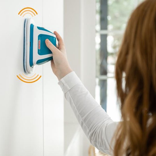 Vrouw bevestigt de blauw-witte Livington MultiScrubber aan een witte kast.