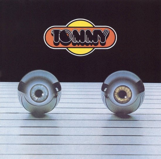 Albumhoes met de tekst TOMMY en twee mechanische ogen met blauwe en bruine irissen.
