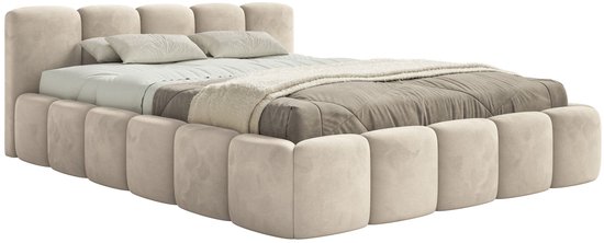 Lit tapissé beige clair avec un design modulaire en blocs sur les côtés et une tête de lit douce.