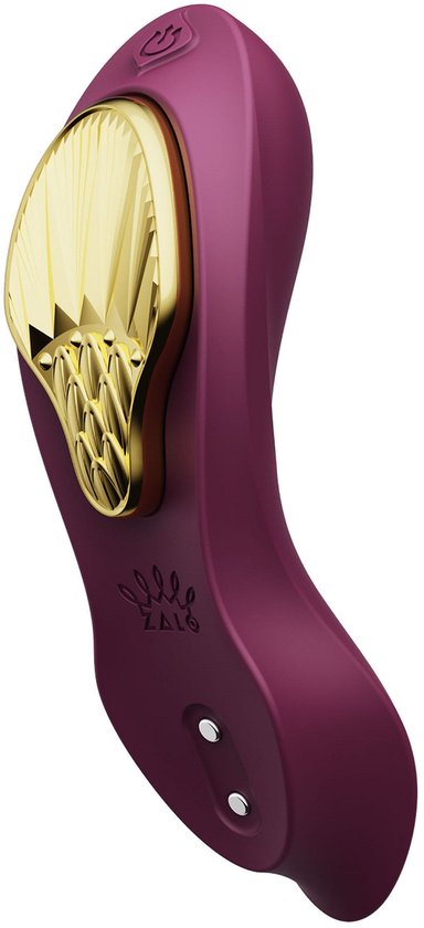 Vibrateur violet avec un insert décoratif doré.