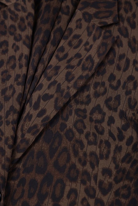 Close-up van de textuur van een bruine blazer met luipaardprint en subtiele krijtstrepen.