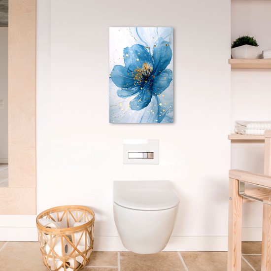 Peinture abstraite d'une fleur bleue avec des éclaboussures dorées, suspendue au-dessus de toilettes.