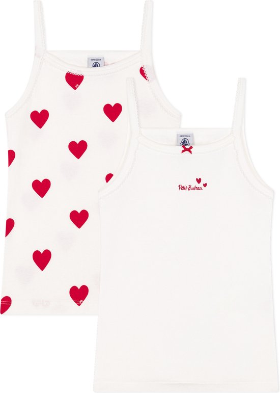 Twee witte topjes, één met rode hartjesprint en 'Petit Bateau' opschrift, de ander effen met strikje.