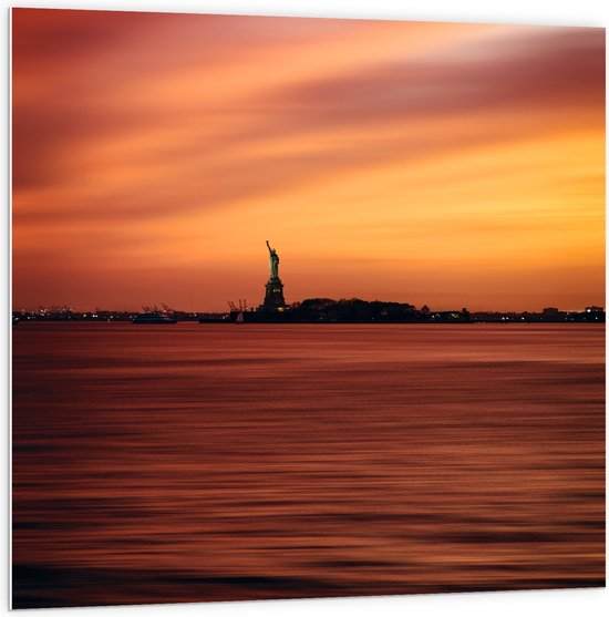 WallClassics - PVC Schuimplaat- Oranje Lucht boven Vrijheidsbeeld in New York - 100x100 cm Foto op PVC Schuimplaat