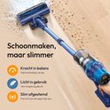 Blauwe steelstofzuiger maakt schoon, met indicatie voor kracht, gewicht en aanpassing.