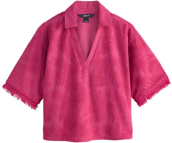 Fuchsia badstof poloshirt met bladmotief, V-hals, 3/4 mouwen en franje.