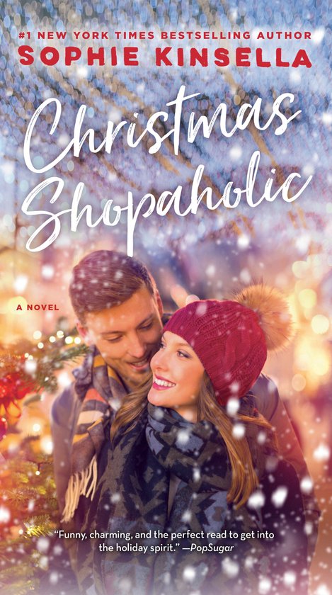 Boekomslag "Christmas Shopaholic" van Sophie Kinsella. Een stel in kerstsfeer, bedekt met sneeuw.