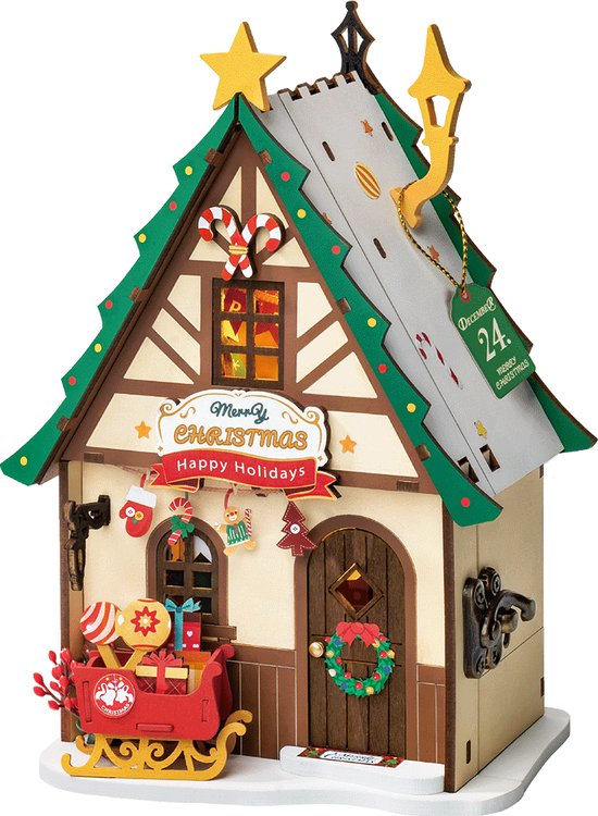 Kersthuisje met een kerstboomvormig dak, slee met cadeaus en "Merry Christmas Happy Holidays".