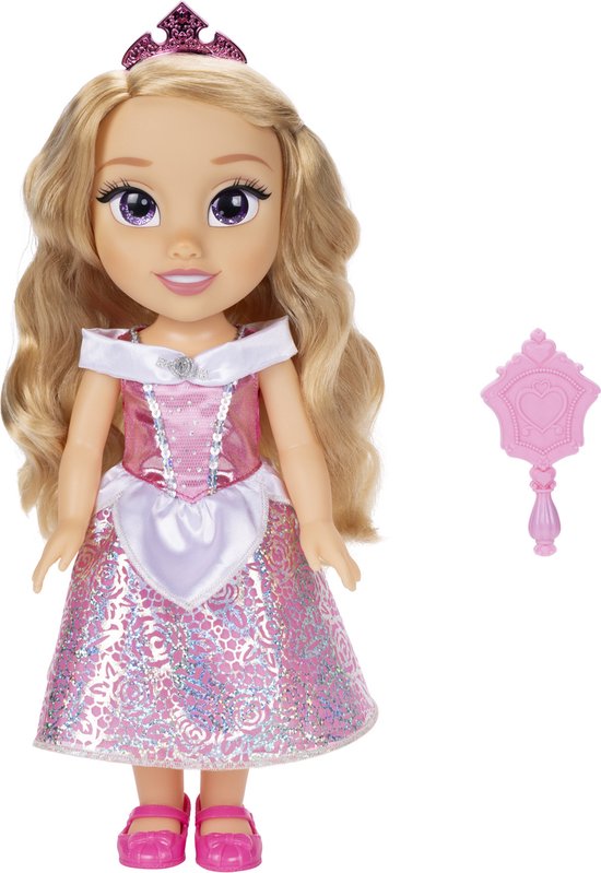 Aurora pop met blonde krullen, roze glitterjurk, witte overlay en roze schoenen. Met roze spiegel.