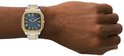 Zilverkleurig herenhorloge met gouden details op kast en schakelband. Blauw met Romeinse cijfers.