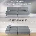 Grijze slaapbank in zitpositie met kussens, en in ligpositie met kussens. Tekst: 'SIT. TEA. RELAX.' en 'LIE. REST. RECHARGE.'