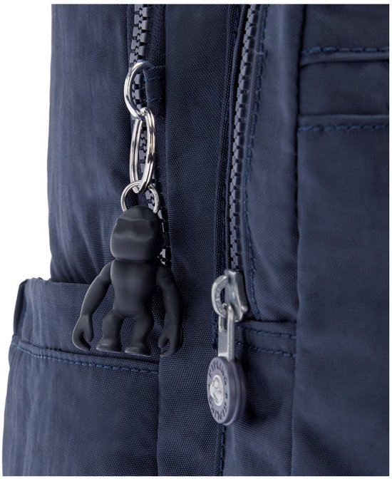 Détail de la fermeture éclair d'un sac à dos Kipling bleu foncé avec un porte-clés singe noir.