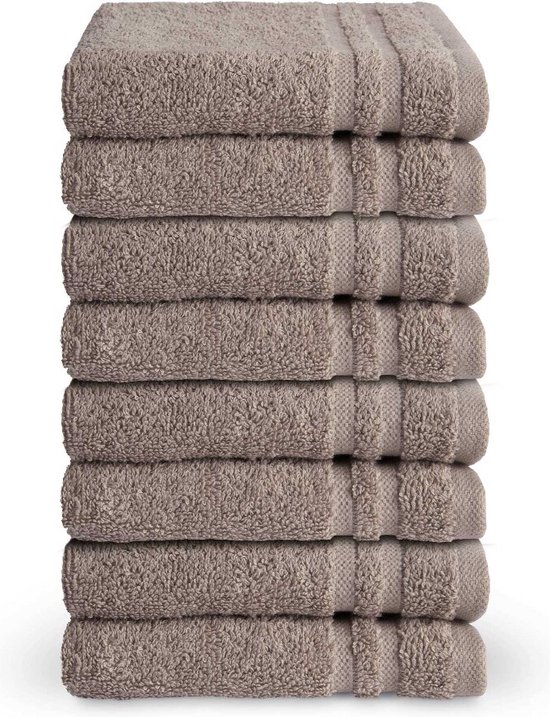 Stapel van acht taupekleurige gastendoekjes met een subtiele ribbelrand.
