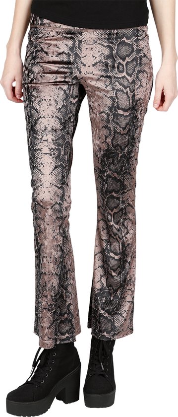 Model in een bruine legging met zwart slangenprintpatroon, uitlopende pijpen en platformlaarzen.