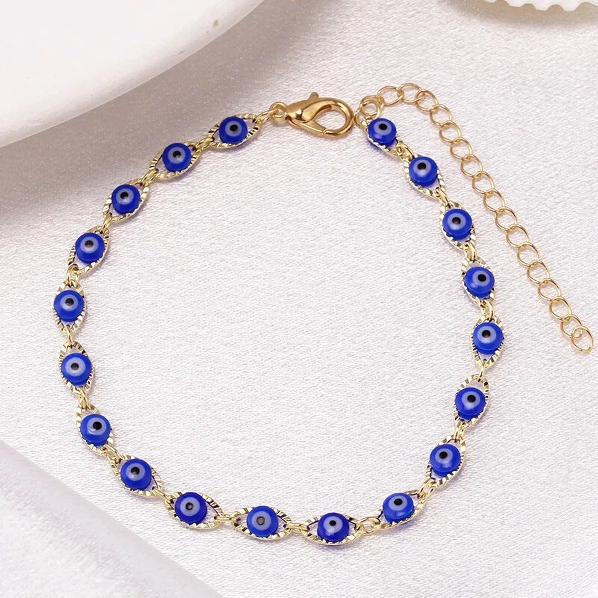 Armbandje boze oogjes - Goudkleurig - Donkerblauwe oogjes