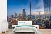 Behang - Fotobehang Het stadslandschap van Dubai met de Burj Khalifa tijdens de schemering - Breedte 360 cm x hoogte 240 cm
