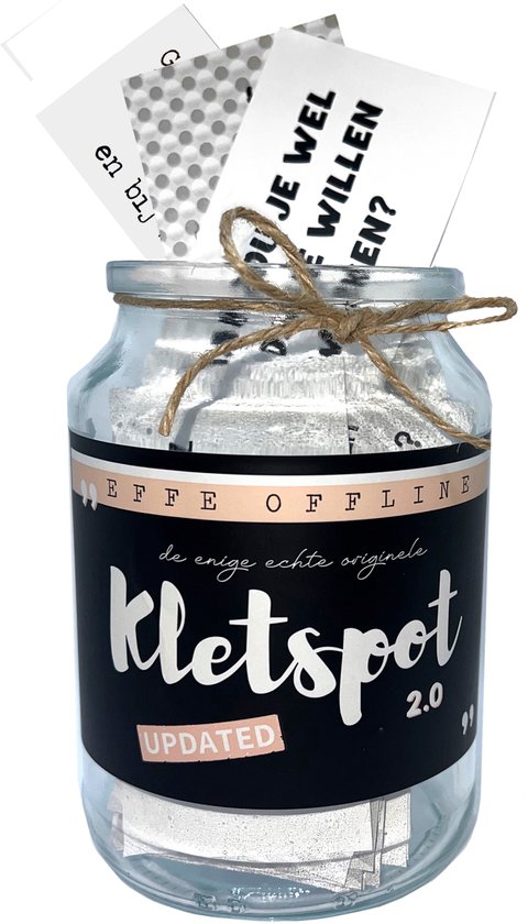 Glazen pot gevuld met zilveren papieren, met een zwart label met 'Kletspot 2.0' erop. Twee kaartjes steken eruit met tekst.
