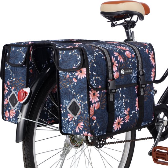 Sacoche double de vélo avec fond bleu marine et imprimé floral rose et blanc.