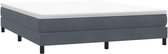 Donkergrijs fluwelen boxspring bedframe met een witte topper, op vier zwarte pootjes.
