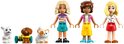 Trois mini-poupées LEGO Friends, un lapin blanc, un chien marron et un chat blanc aux taches orange.