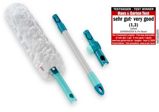 Plumeau blanc et duveteux, manche et support turquoises, avec label de test 'Sehr gut'.