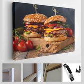 Twee heerlijke zelfgemaakte hamburgers van rundvlees, kaas en groenten op een oude houten tafel. Vet ongezond voedsel close-up - Moderne kunst canvas - Horizontaal - 1931683718
