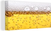 Canvas Schilderij Bierbubbels in glas met bier - 80x40 cm - Wanddecoratie