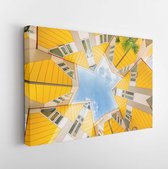 Canvas schilderij - Star shapes formed where six Cube houses tilt into one another and intersect in Rotterdam, a quirky bright yellow architecturally unusual angular cube shape apa