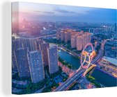 Canvas Schilderij De Chinese stad Tianjin tijdens zonsondergang - 180x120 cm - Wanddecoratie XXL
