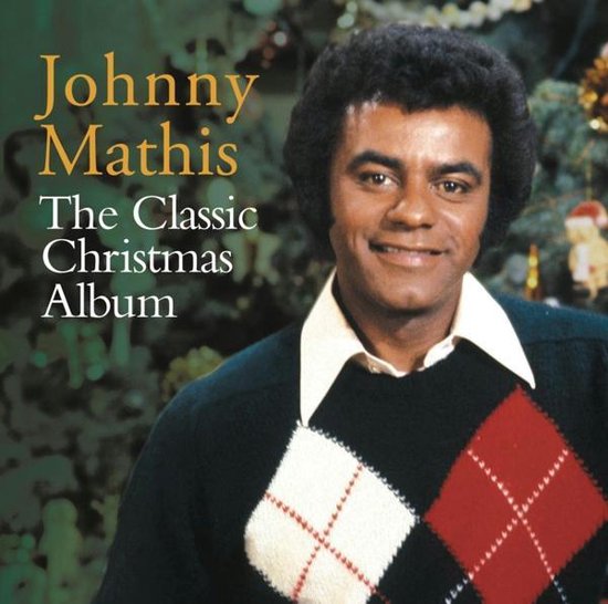 Johnny Mathis albumhoes met een kerstboom op de achtergrond en een portret van Johnny Mathis in een gebreide trui met ruitenpatroon.