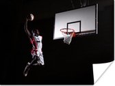 Poster Een basketballer dunkt de basketbal in de basket - 40x30 cm