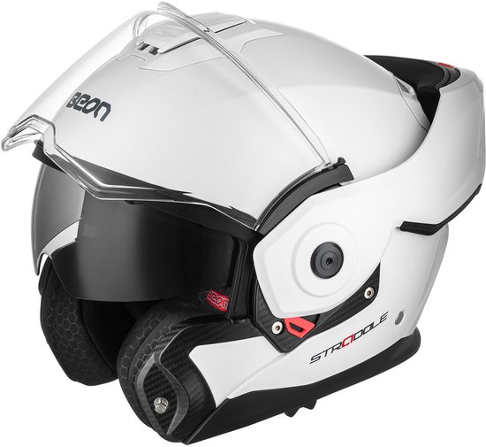 Witte systeemhelm met opengeklapt vizier en zonnevizier, met rode accenten en carbon details.