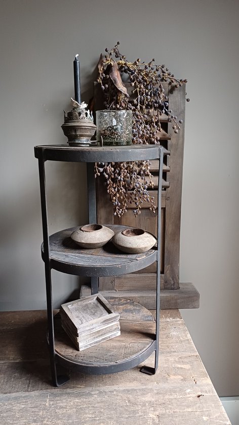 Robuuste etagère met drie lagen van donkerbruin hout en een metalen frame op een houten tafel.