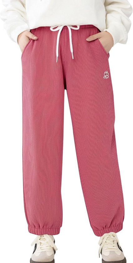 Model draagt een roze corduroy joggingbroek met witte trekkoorden, elastische boorden en een klein wit logo.