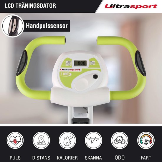 Close-up van het stuur met LCD-display van de witte en groene hometrainer, met tekst "LCD Trainingsdata" en "Handpulssensor".