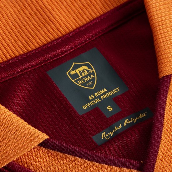 Wijnrood voetbalshirt met oranje kraag en boorden. Label toont 'AS ROMA OFFICIAL PRODUCT S Recycled Polyester'.