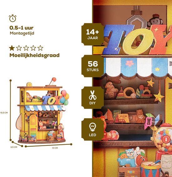 Gele speelgoedwinkel van 10,5 cm hoog, met 'TOY'-letters, ballonnen, een trein en een snoepautomaat. Bevat 56 stukjes.
