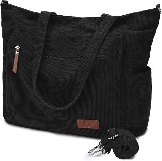 Sac fourre-tout cabas noir en velours côtelé avec étiquette en cuir, fermeture éclair, deux poignées et une bandoulière amovible.