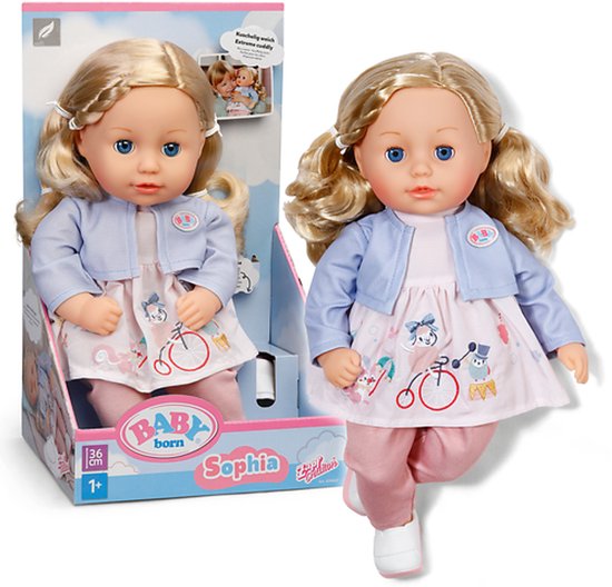 BABY born pop Sophia (36cm) in verpakking en ernaast. Pop met blond haar, blauwe ogen, roze jurk, blauw vestje, roze broek en witte schoenen.