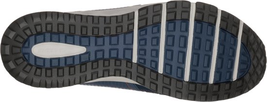 Semelle d'une chaussure de randonnée bleu foncé avec un profil gris et bleu.