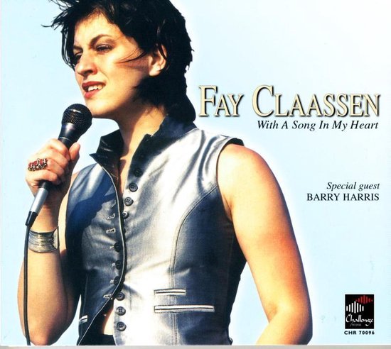 Fay Claassen met een zilveren giletje, zingt in een microfoon. Tekst: FAY CLAASSEN With A Song In My Heart.