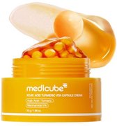 Medicube KOJIC ACID TURMERIC VITA CAPSULE CREAM pot met oranje capsules en gele crème.